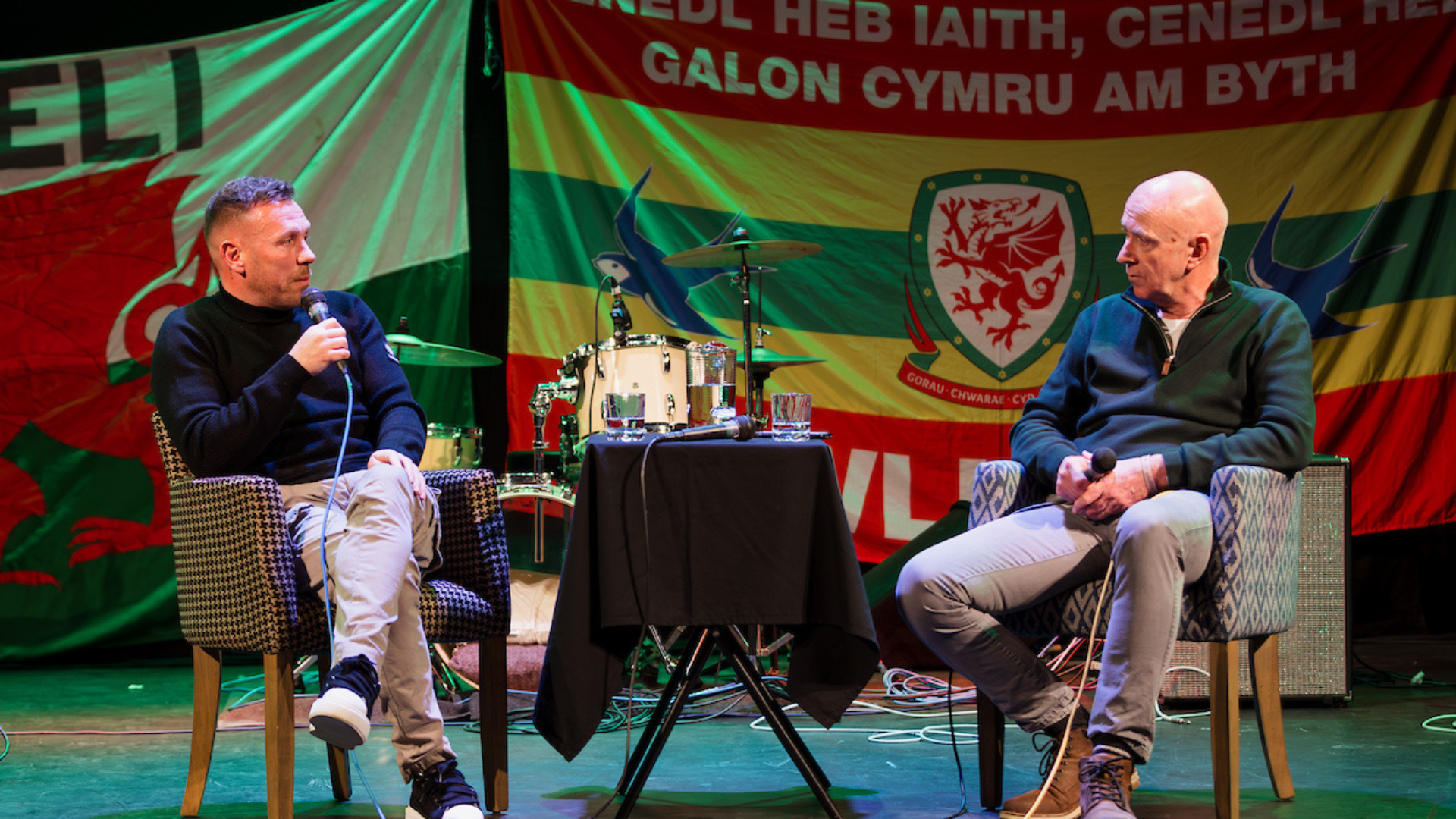 Craig Bellamy and Ian Gwyn Huws in conversation, sat on chairs either side to a small table