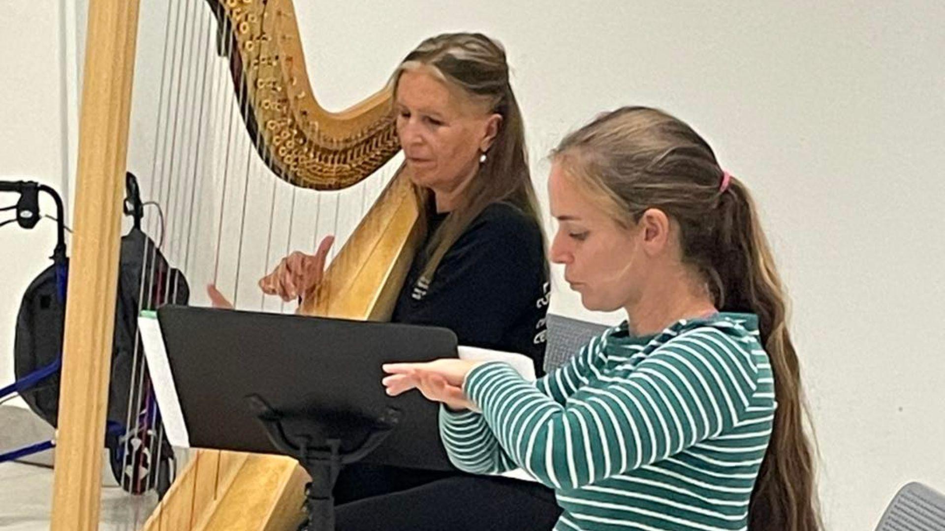 Harpist Helen Wyn Pari playing the harp and dancer Angharad Harrop leading the class