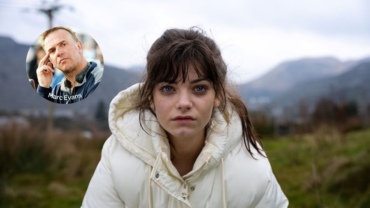 Image of Effi in a white coat out in the countryside starring into the camera