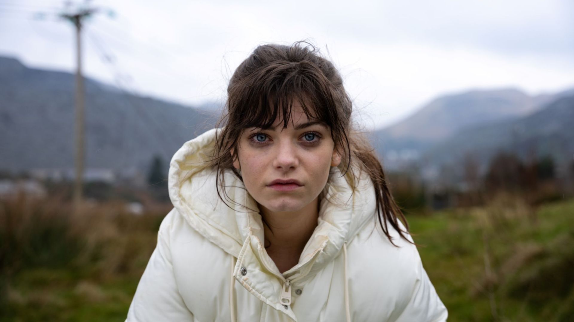 Image of Effi looking into the camera in the countryside