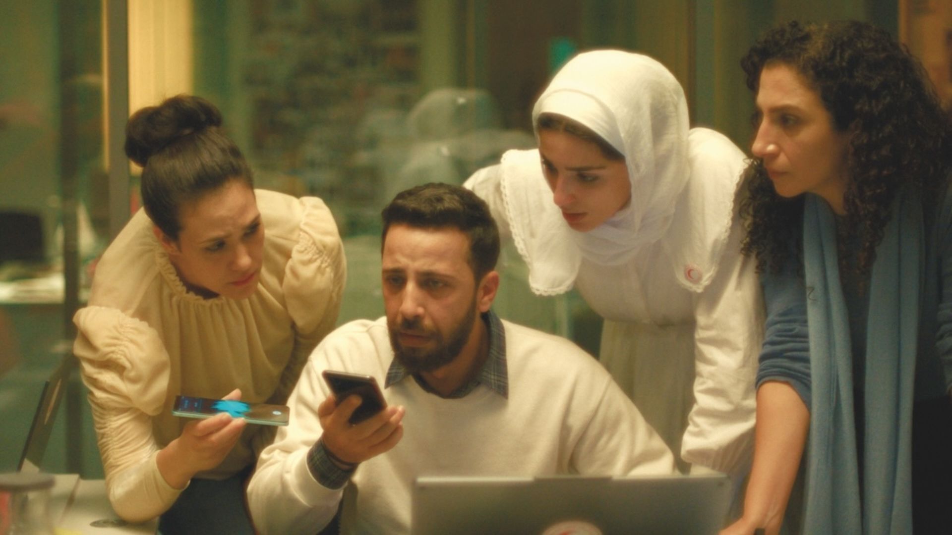 Group of people on phones and laptop looking worried