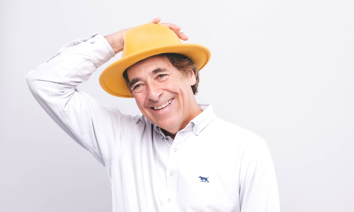 A photo of Mark Steel wearing a yellow hat on his head