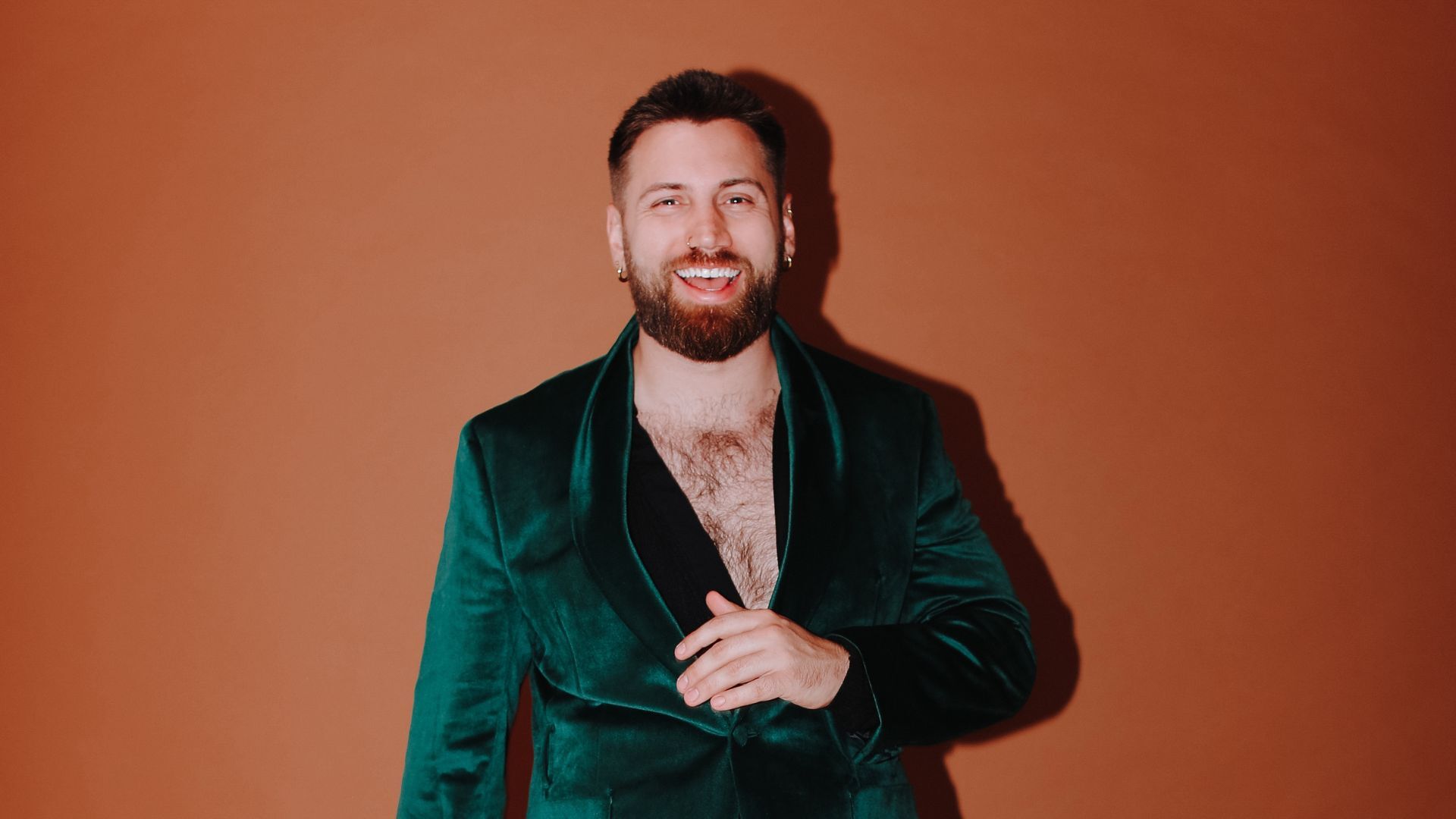 Morgan Rees smiling and wearing a dark green velvet jacket