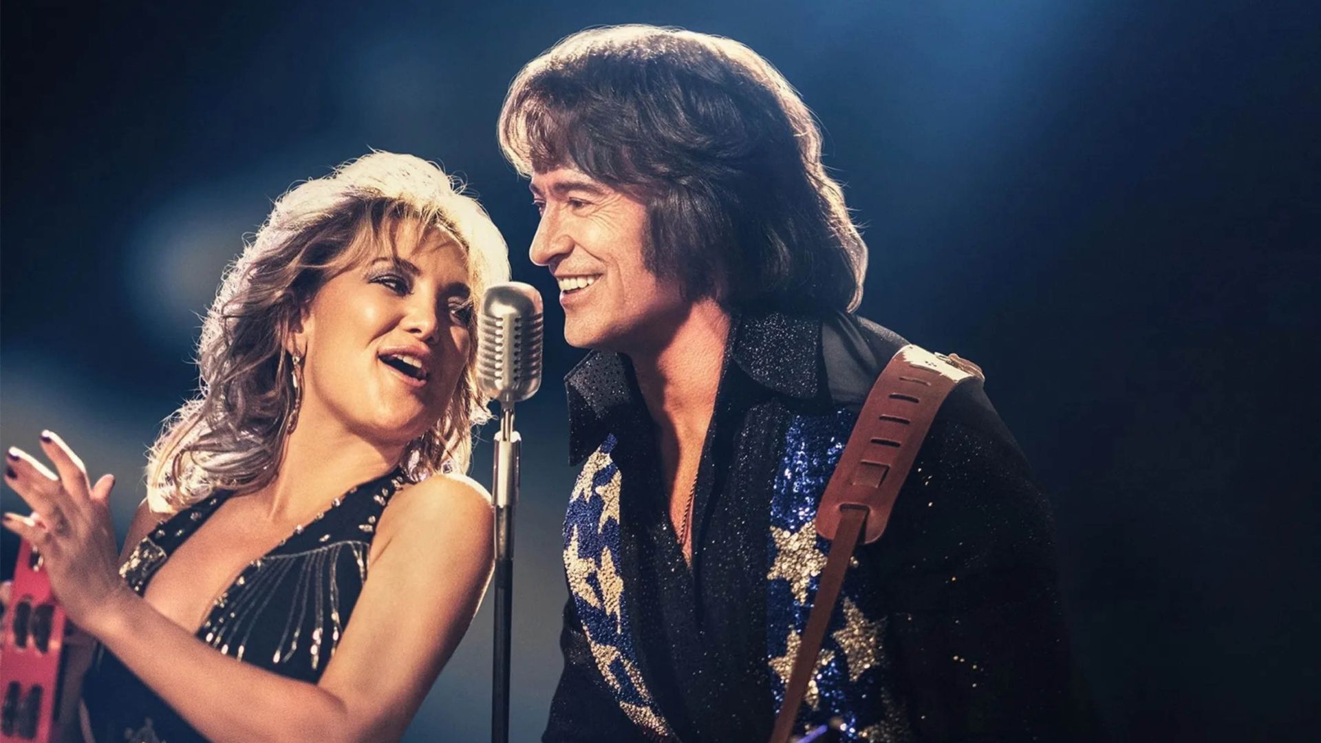 Two singers performing on stage, man and woman