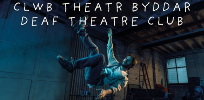 Man falling through the air in a shed with text Clwb Theatr Byddar / Deaf Theatre Club in white lettering