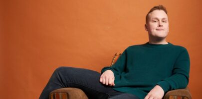 Josh Jones sitting on an armchair