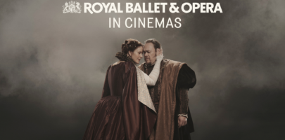 a man and woman standing face to face in an embrace wearing dark Tudor style clothing