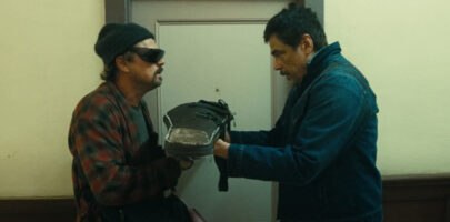 Two men in a corridor looking stressed