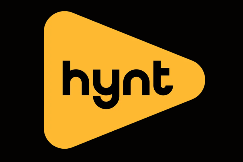 HYNT logo, yellow triangle pointing to the right on a black bachground, with black lettering