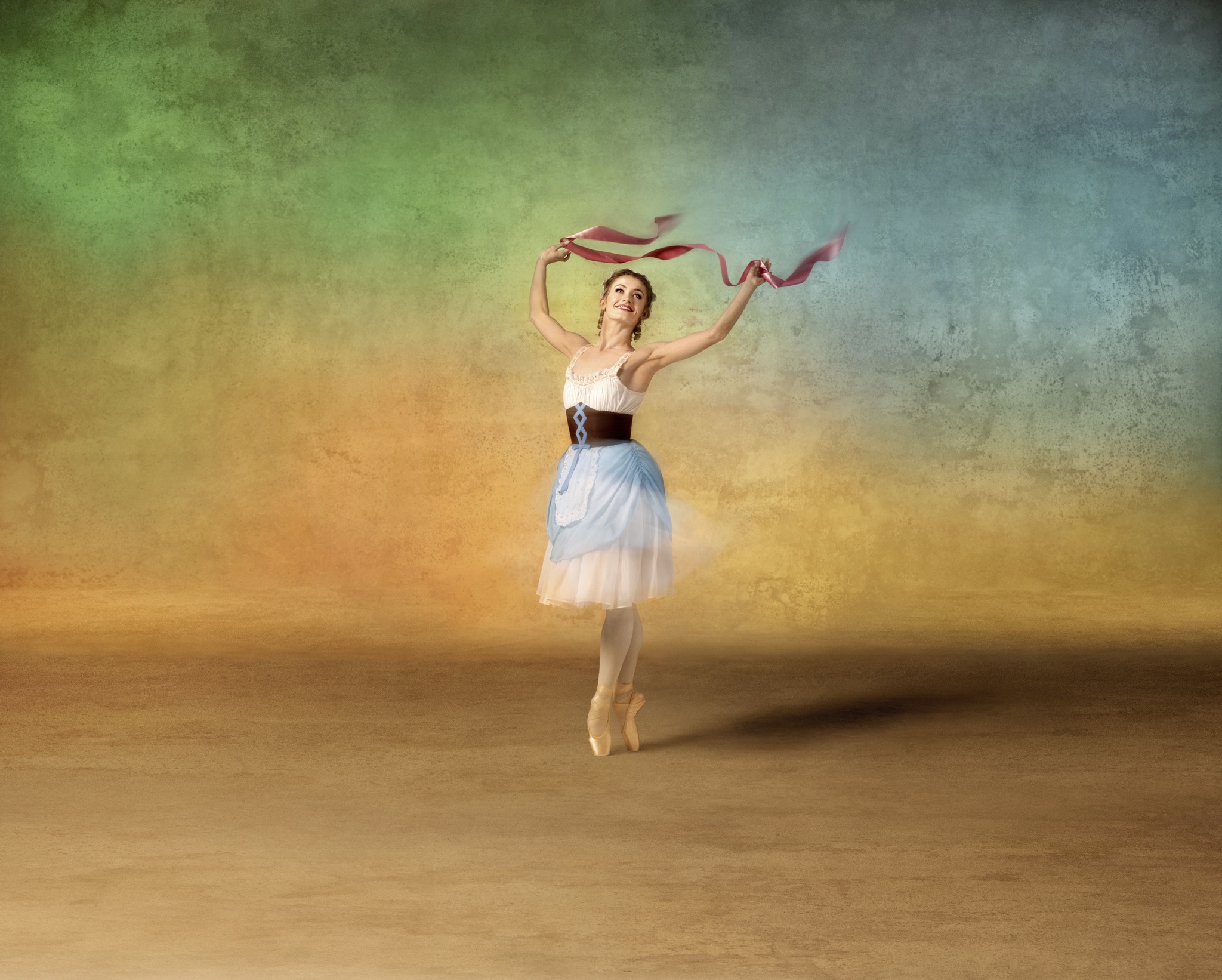 Photo of a ballerina in a traditional costume dancing gracefully against a colourful textured background