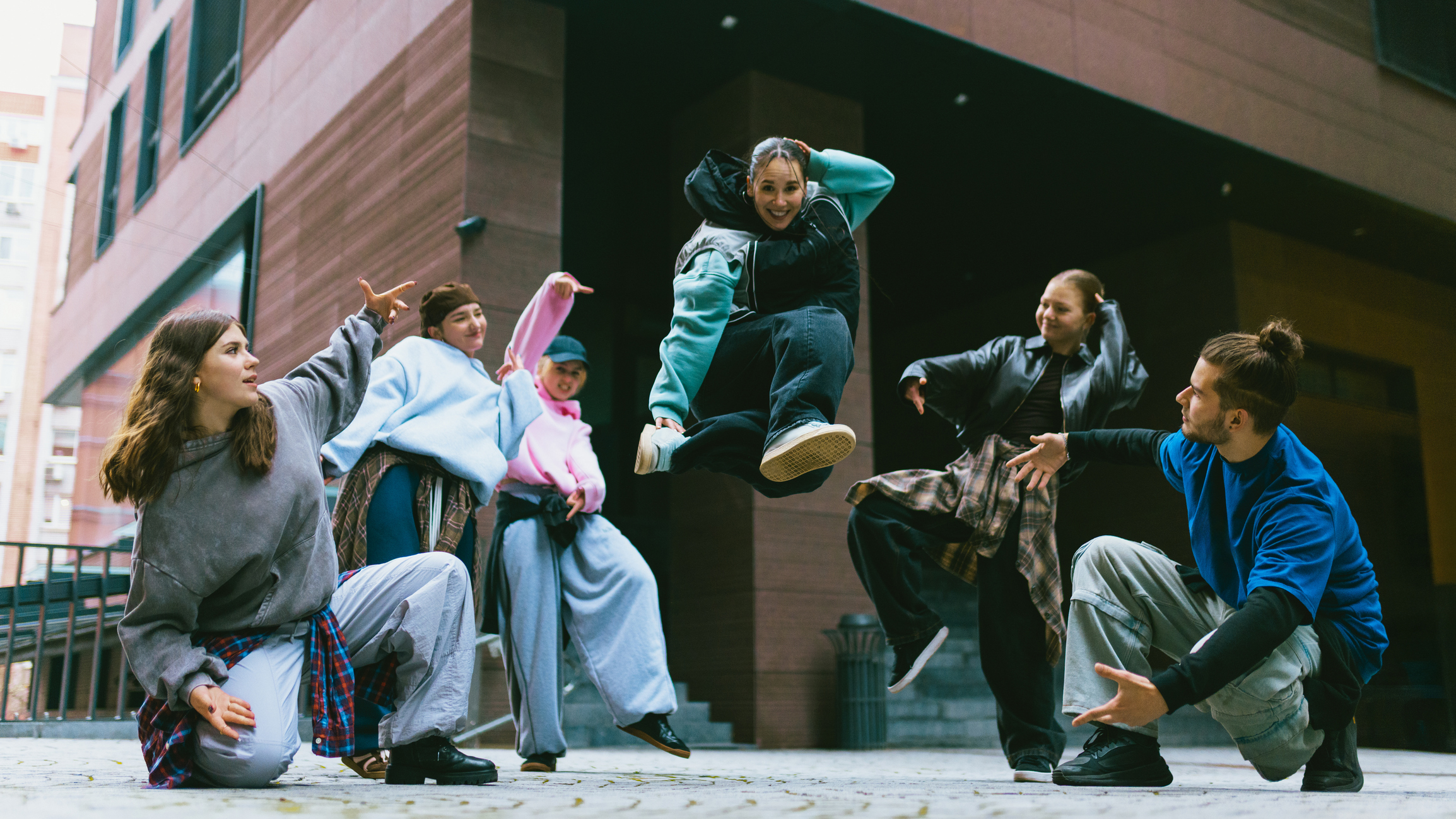 Group of young people outside dancing